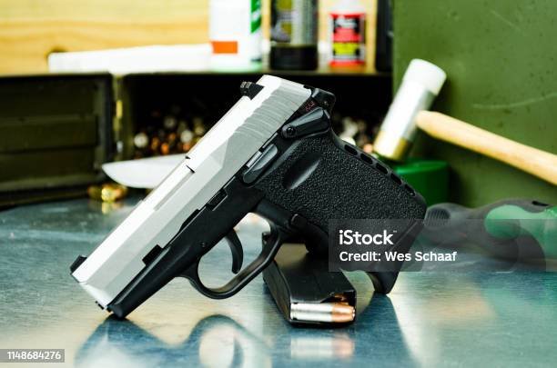 Subcompact 9mm pistol on a gunsmith's workbench—visual suited for a pre-purchase inspection and test-fire checklist for a micro-compact CCW pistol.