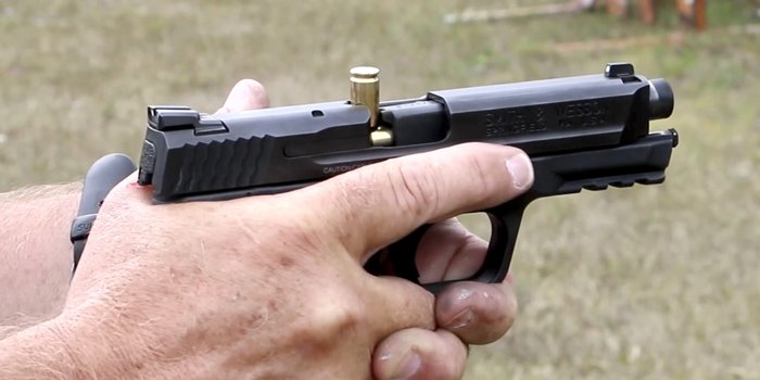 What is a “Stovepipe” Malfunction is & How to Clear It | Locked ... — clear photo of a stovepipe (ejected casing stuck vertically in the pistol ejection port), illustrating common reliability/jam issues.