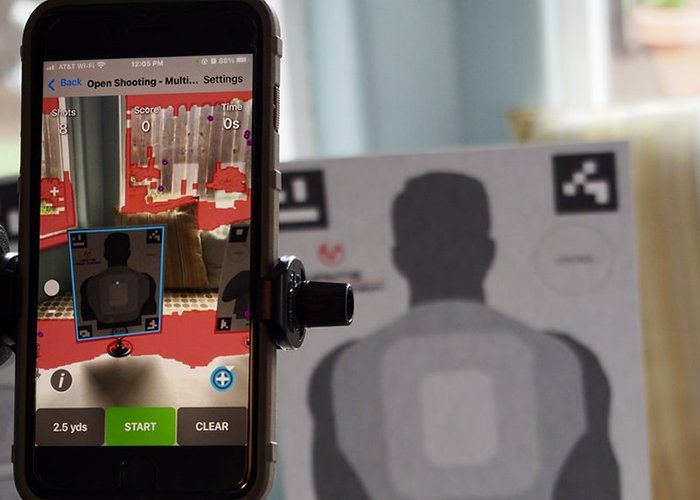 Mantis Laser Academy dry-fire training setup showing a laser device and smartphone app — visually represents short, frequent dry-fire sessions for skill maintenance and measurable practice progress.