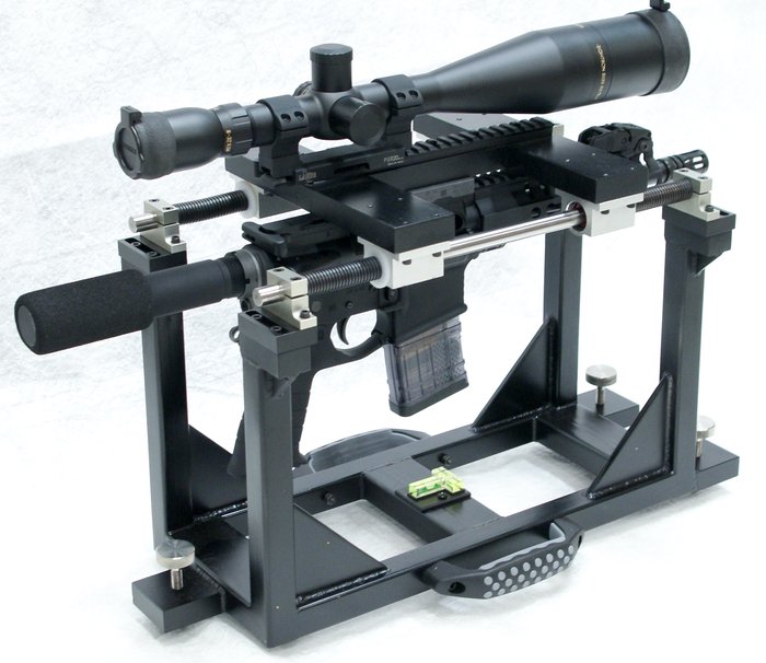Universal Precision Test Fixture for Firearms — a precision test/rest setup that visually represents standardized accuracy and reliability testing protocols used in evaluating a handgun like the APX A1.