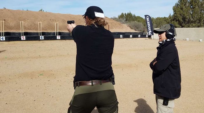 NRA Women | Take a New Shooter to the Range in 6 Steps — instructor training a student, representing beginners receiving tactical shooting instruction